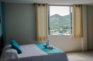 a bedroom with a bed and a large window at HOTEL DE LA PEÑA INN in Santo Domingo Tehuantepec