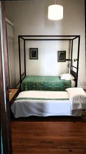 a bedroom with two beds in a room at Casa Chacabuco Tandil in Tandil