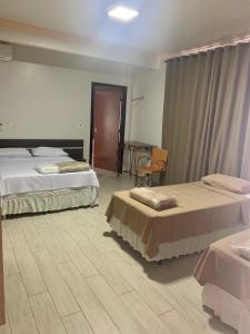 Postel nebo postele na pokoji v ubytování Hotel Paradizzo