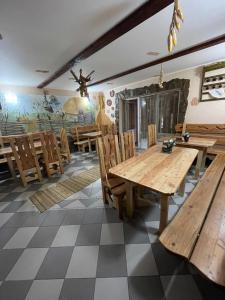 a dining room with wooden tables and chairs at РІТО in Slavske