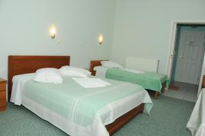 Posteľ alebo postele v izbe v ubytovaní Costa-Rini Hotel