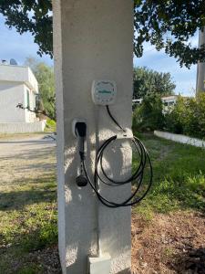 a wall with a phone plugged into a pole at case per vacanze torre incina in Polignano a Mare