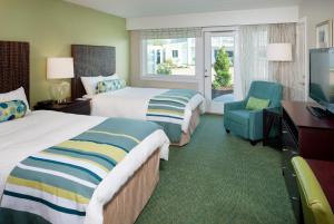 a hotel room with two beds and a television at Sea Crest Beach Hotel in Falmouth