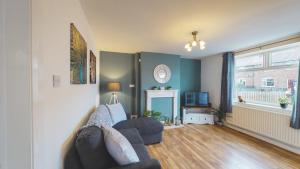 a living room with a couch and a window at Stunning 3-Bed house in Chester by 53 Degrees Property, ideal for Contractors & Families, FREE Parking - Sleeps 7 in Chester
