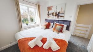 a bedroom with a large bed with two towels on it at Stunning 3-Bed house in Chester by 53 Degrees Property, ideal for Contractors & Families, FREE Parking - Sleeps 7 in Chester