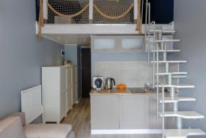 a kitchen with a white refrigerator next to a counter at Holiday Home SLAVIA NEW 012 in Międzyzdroje