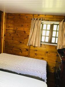 a bedroom with a bed and a window at Casa Ilha do Mel in Ilha do Mel