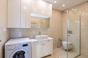 a bathroom with a washing machine and a sink at Plaka apt Homeleader in Plaka +46 photos