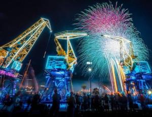 una multitud de personas viendo un espectáculo de fuegos artificiales por la noche en Przytulny Apartament en Szczecin