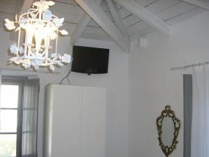 a living room with a tv and a refrigerator at Villa Sunrise in Hydra