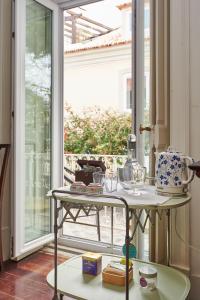 卡斯凱什的住宿－Ninho Salino，窗户前的桌子和盘子