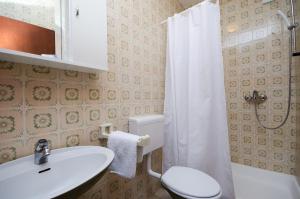 a bathroom with a sink and a toilet and a shower at Apartments Marija & Lino in Lopar