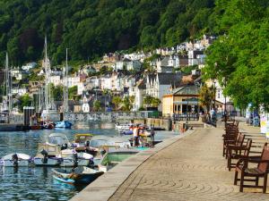 a dock with boats in a body of water at Upper Deck in Dartmouth