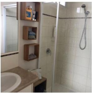 a bathroom with a shower and a sink at Beach Cabin Apollo Bay in Apollo Bay