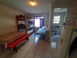 a small room with a bunk bed and a couch at Apartamento mobiliado no Canto do Forte - Praia Grande - SP Férias, temporada, feriados in Sao Paulo
