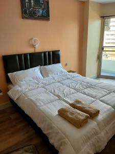 a large white bed with two pillows on it at View Talay 1B by Fernando in Pattaya South