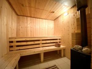 a sauna with a wooden bench in a room at Eco Centre Talovskoe in Topilo