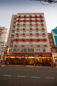 a tall building on a city street with a street at San Silvestre Hotel in Passo Fundo