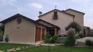 a house with a car parked in front of it at Residenza Airone in Vicenza +9 photos
