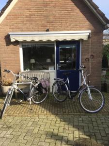 due biciclette parcheggiate di fronte a una casa di B&B Vogelhof a Wapenveld