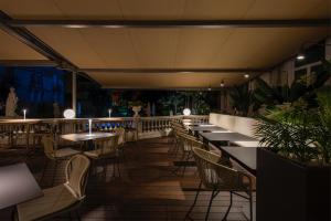a row of tables and chairs in a restaurant at Grand Hotel Liberty in Riva del Garda
