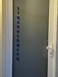 a door with the word bathroom written on it at Strandläufer in Gelbensande