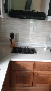 a kitchen counter with a stove top in a kitchen at Aimé Anaïs in Abaga +8 photos