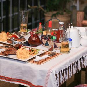 stół z talerzami jedzenia i napojów w obiekcie Airport Link Guest House w mieście Entebbe