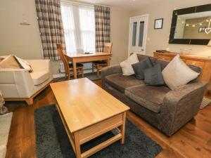 a living room with a couch and a table at Cooper's Cottage in Morpeth