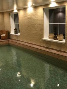 a swimming pool with green water in a building at Losehill House Hotel & Spa in Hope