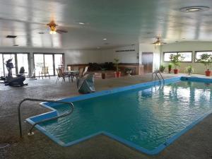 a swimming pool in a large room at Super 8 by Wyndham Cut Bank in Cut Bank