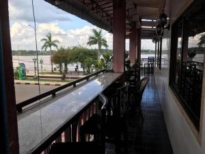a bar with chairs and a view of the water at Mekong Crossing Guesthouse - Restaurant & Pub in Kampong Cham
