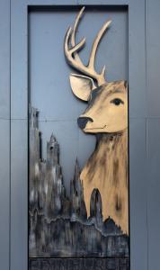 a painting of a statue of a giraffe on a wall at voco Edinburgh - Haymarket, an IHG Hotel in Edinburgh