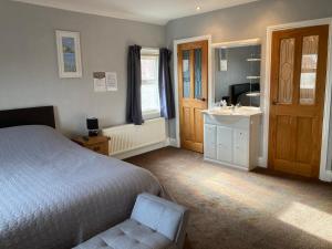 a bedroom with a bed and a sink at Rivington House Room only in Whitby +8 photos