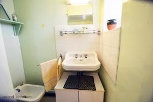a small bathroom with a sink and a toilet at La Petite Maison in Cesseras