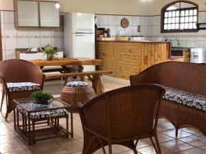 a restaurant with a table and chairs and a kitchen at casa em Barra de Cunhaú-RN in Barra do Cunhau