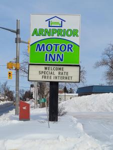 a sign for a motor inn in the snow at Arnprior Motor Inn in Arnprior