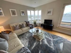 a living room with a couch and a table at Penthouse Apartment in Kilkenny