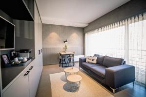 ein Wohnzimmer mit einem Sofa und einem Tisch in der Unterkunft Apart! & Moment! in De Haan