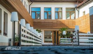 a building with a fence and chairs in front of it at Konak Sibiu in Sibiu