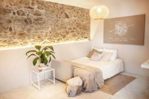 sypialnia z łóżkiem i doniczką w obiekcie 8 - LA GUARIDA DE TARIFA - Bajo B - ENJOY TARIFA w mieście Tarifa