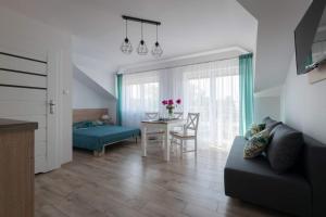 a living room with a couch and a table at Pensjonat Bursztyn in Dąbki