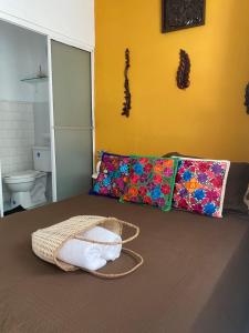 a bedroom with a bed with a basket on it at Casa San Juan in Cartagena de Indias