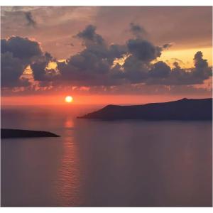 a sunset over a body of water at NEOKLASSIKO KOUKOULI in Fira