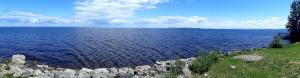 a large body of water with rocks on the shore at Motel Castille in Roberval