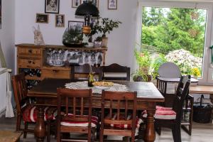 a dining room with a wooden table and chairs at Zakątek Szczęścia Eko Agroturystyka in Kiwity +93 photos