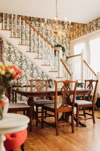 a room with a staircase with chairs and a table at The Rochester Inn in Sheboygan Falls