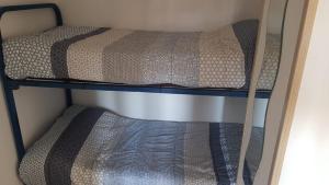 a couple of bunk beds in a room at Atico Isaac Albeniz in La Pineda