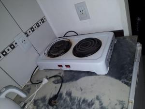 a white stove in a corner of a kitchen at CielosdeColon I in Colón
