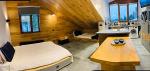 ein Schlafzimmer mit einem Bett und einem Tisch in einem Zimmer in der Unterkunft Golden Box Pamporovo in Pamporowo + 9 Fotos